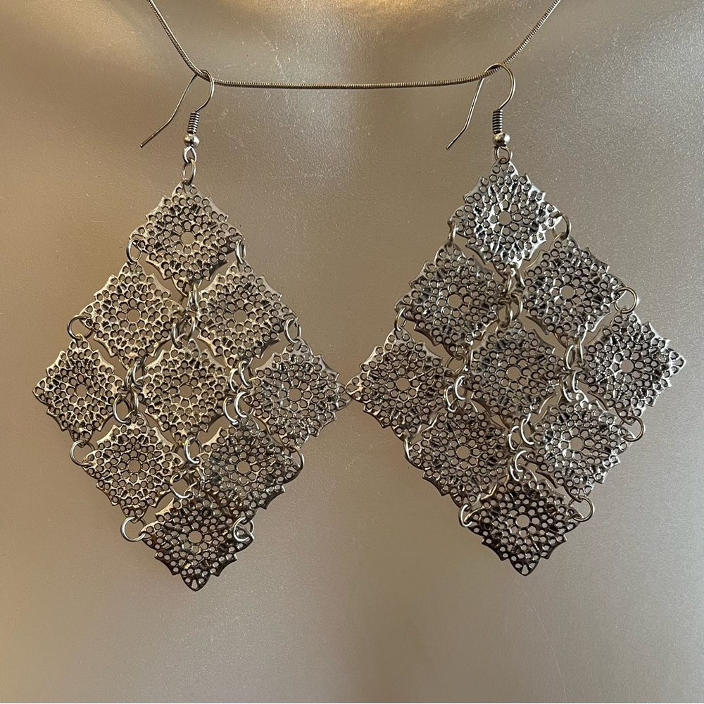 Diamond shape silver chandelier earrings.